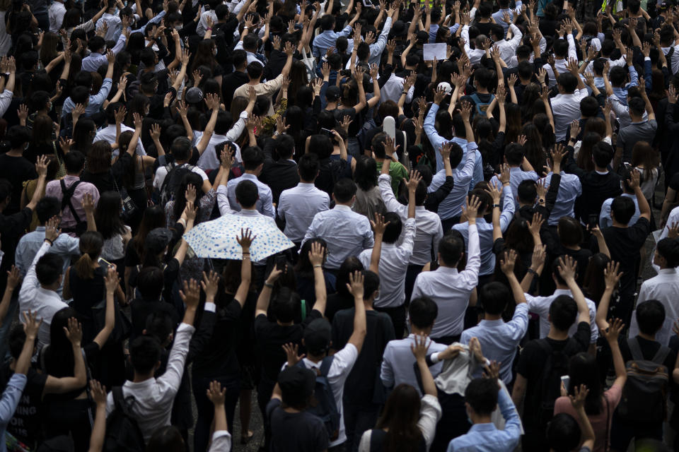 People display opened palm with five fingers, signifying the five demands of anti-government protesters during a march at Central district in Hong Kong, Wednesday, Oct. 2, 2019. Thousands marched in the business district denouncing the police shooting of a teenage protester during widespread anti-government demonstrations that marred China's National Day. (AP Photo/Felipe Dana)