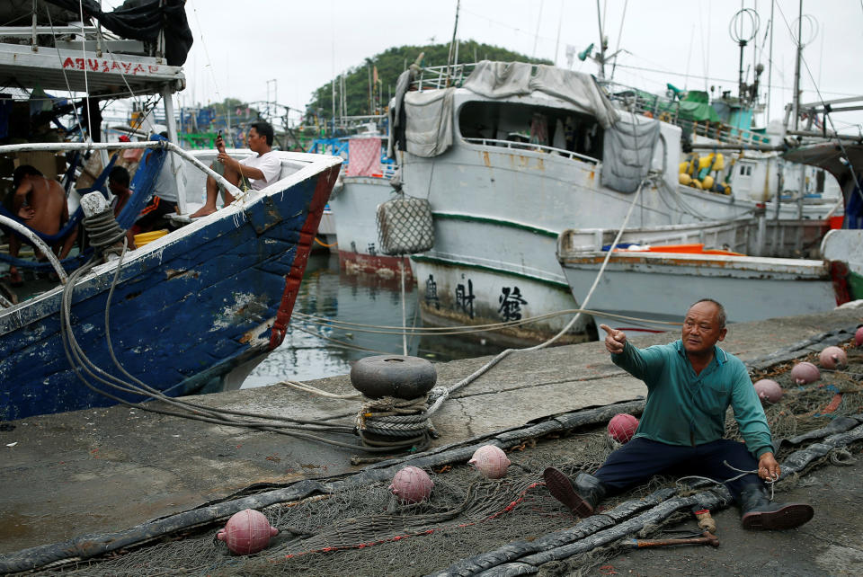 A fisherman arranges a net as Typhoon Nepartak approaches in Yilan