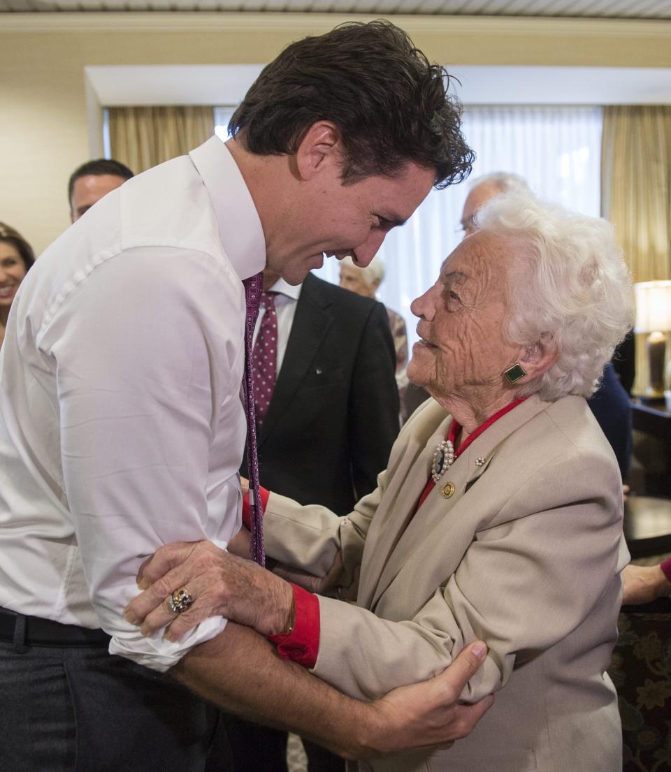 FILE - Liberal leader Justin Trudeau greets former Mississauga mayor Hazel McCallion during a campaign event in a senior's home Friday, Oct. 16, 2015, in Mississauga, Ontario. McCallion, who led one of Canada’s largest cities into her 90′s, died Sunday morning, Jan. 29, 2023, leaving behind a legacy of feisty advocacy and more than three decades of nearly unchallenged leadership. She was 101. (Paul Chiasson/The Canadian Press via AP, File)