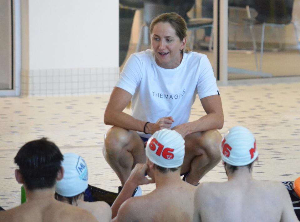 Olympic swimmer Kasia Wasik speaks to Michigan Lakeshore Aquatics swimmers during a clinic on Saturday, April 6, at Holland Community Aquatic Center.