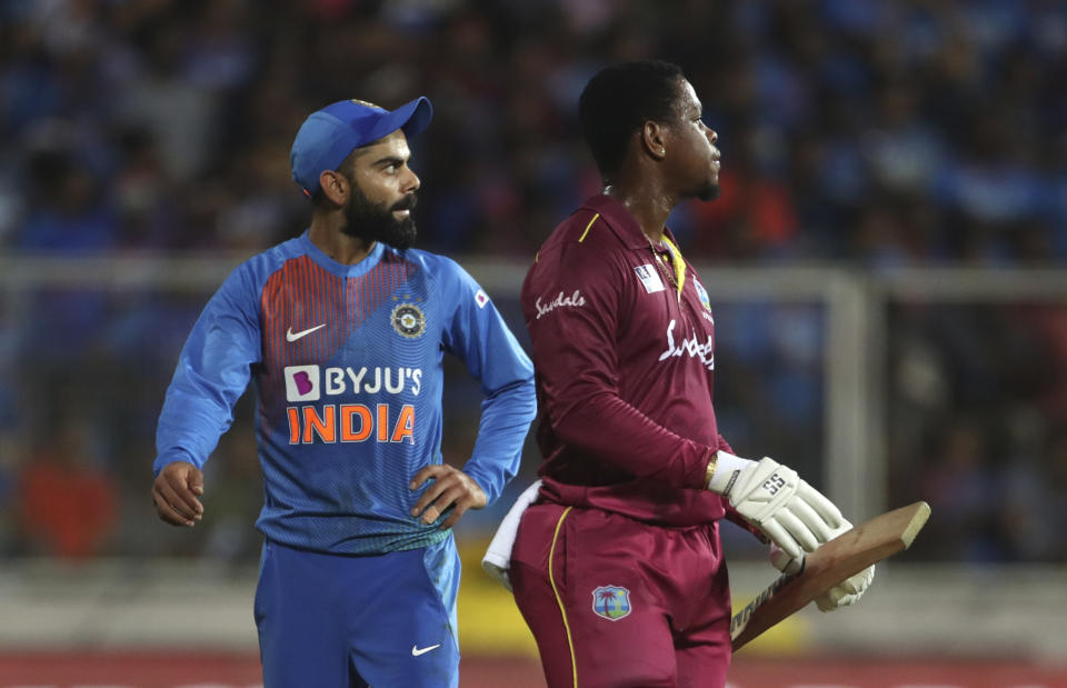 India's captain Virat Kohli, left, and West Indies' Shimron Hetmyer watch the replay of Hetmyer's dismissal as they await umpire's decision during the second Twenty20 international cricket match between India and West Indies in Thiruvanathapuram, India, Sunday, Dec. 8, 2019. (AP Photo/Aijaz Rahi)