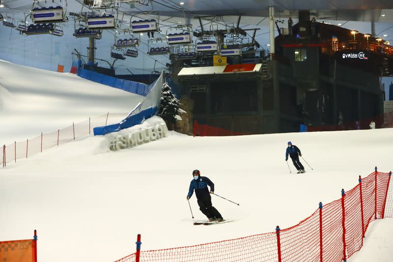 People wearing protective face masks ski at Ski Dubai during the reopening of malls, following the outbreak of the coronavirus disease (COVID-19), at Mall of the Emirates in Dubai