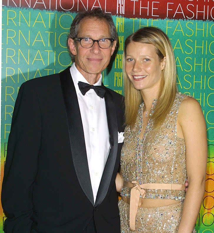 Bruce in a black tuxedo and Gwyneth in a beaded dress with ribbon detail