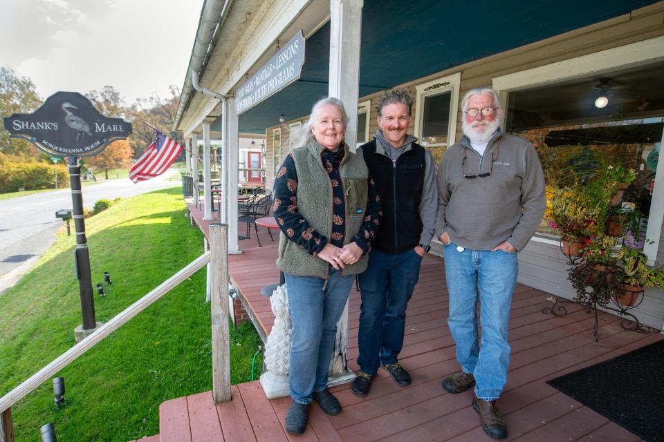 From the left, Liz, Devin and Steve Winand outside Shank's Mare along the Susquehanna River, the store's home in a vintage general story since 1997 in Lower Windsor Township.