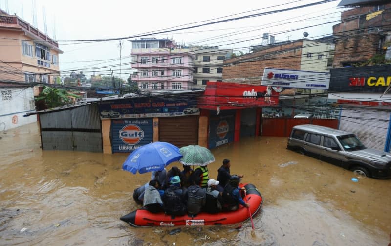 Security force members use an inflatable raft to bring residents to safety from a flooded area near the bank of the overflowing Bagmati River following heavy rains, in Kathmandu. Dipen Shrestha/ZUMA Press Wire/dpa