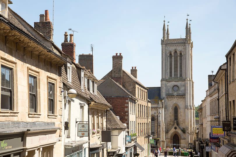 St. Michael's Church tower and buildings in Ironmonger Street, Stamford, Lincolnshire, England, UK.