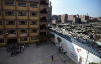 The walls of the Mahaba School in Cairo's Ezbet al-Nakhl shanty town separate children from piles of garbage