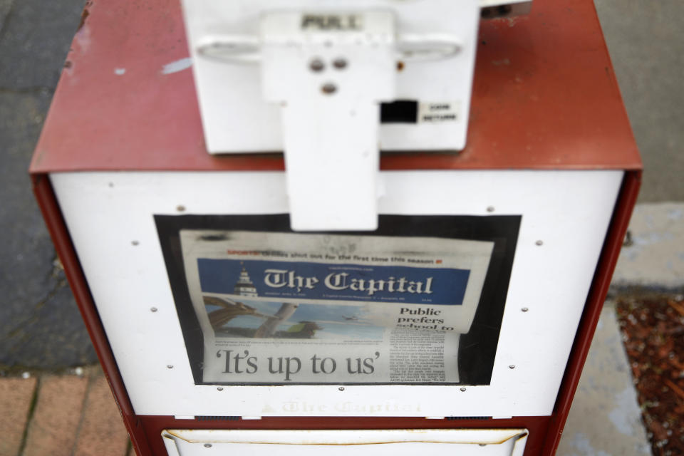 FILE - This April 15, 2019 file photo shows a copy of the day's Capital Gazette newspaper in a newsstand in Annapolis, Md. An armed man walked into the paper's newsroom and killed four journalists and another employee last June. (AP Photo/Patrick Semansky, File)