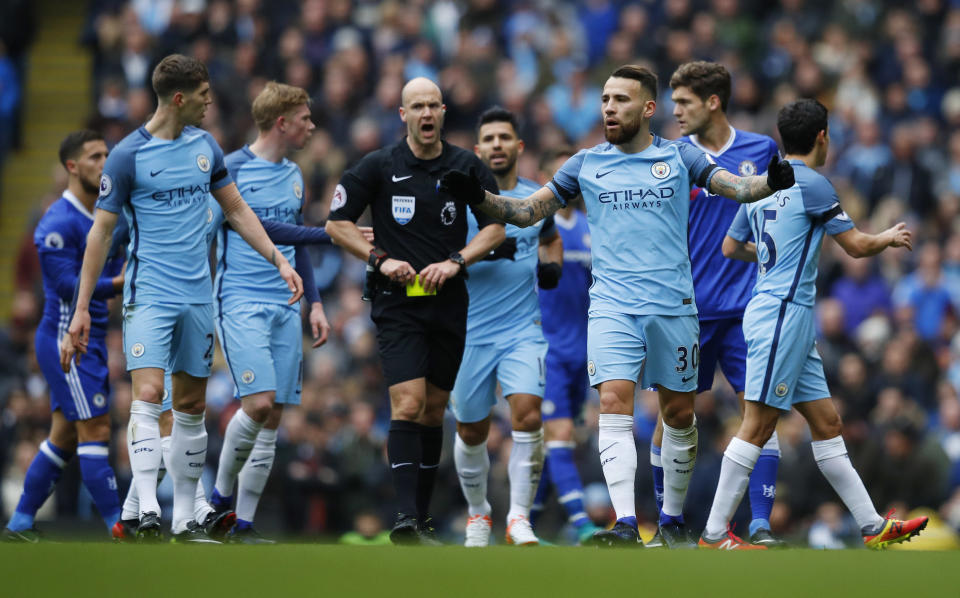 Britain Football Soccer - Manchester City v Chelsea - Premier League - Etihad Stadium - 3/12/16 Manchester City's Nicolas Otamendi is shown a yellow card by referee Anthony Taylor Reuters / Phil Noble Livepic EDITORIAL USE ONLY. No use with unauthorized audio, video, data, fixture lists, club/league logos or "live" services. Online in-match use limited to 45 images, no video emulation. No use in betting, games or single club/league/player publications. Please contact your account representative for further details.