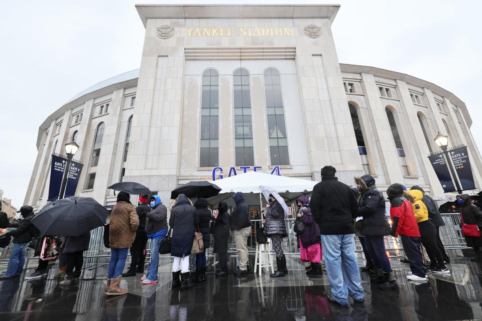 People wait in line to enter a coronavirus vaccination site at Yankee Stadium on February 5, 2021 in the Bronx borough of New York City.  / Credit: Michael M Santiago/GettyImages/Getty Images