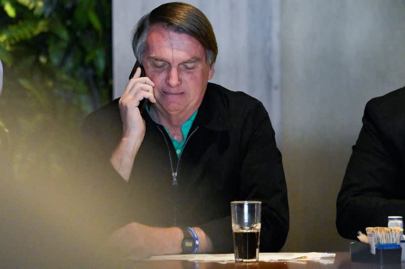 Brazil's former President Jair Bolsonaro sits in a restaurant in Belo Horizonte