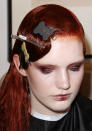 <b>Behind-the-scenes at Oscar de la Renta's AW13 New York Fashion Week show</b><br><br>A model closes her eyes as her bruised, burgundy eyes and lips are applied.<br><br>©Rex