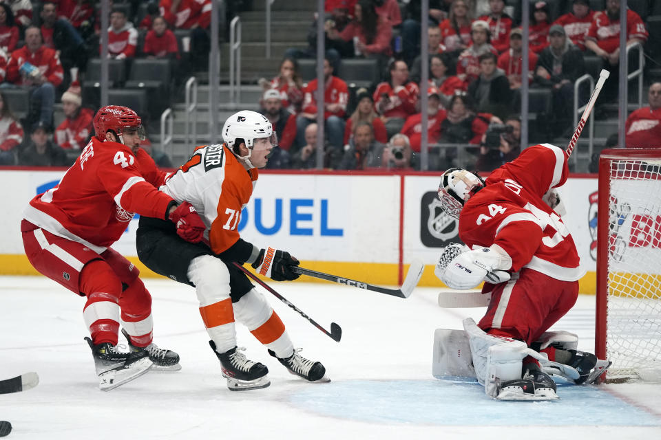 Detroit Red Wings goaltender Alex Lyon (34) stops a shot by Philadelphia Flyers right wing Tyson Foerster (71) during the first period of an NHL hockey game, Thursday, Jan. 25, 2024, in Detroit. (AP Photo/Carlos Osorio)