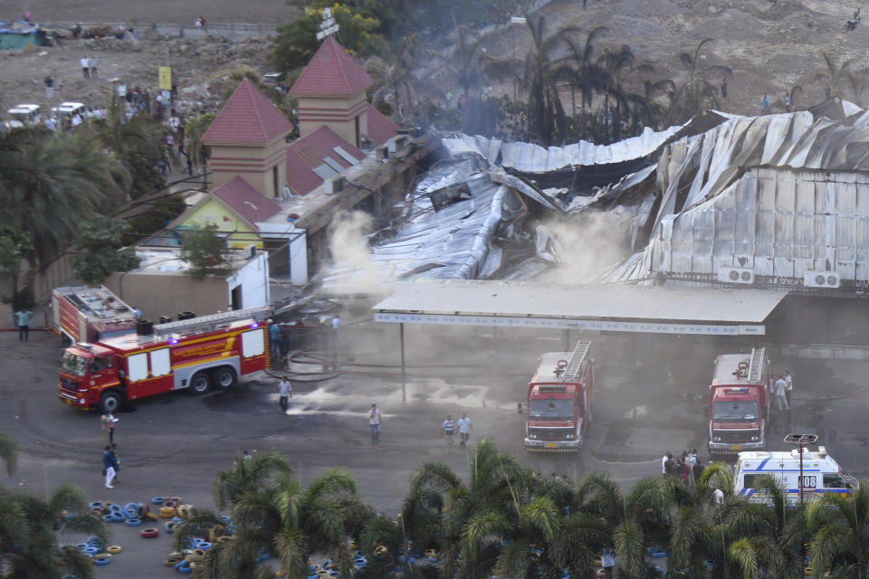 Firefighters douse a fire which broke out in a fun park, in Rajkot in the Indian state of Gujarat, Saturday, May 25, 2024. A massive fire broke out on Saturday in a fun park in western India, killing more than ten people and injuring some others, news reports said. (AP Photo/Chirag Chotaliya)