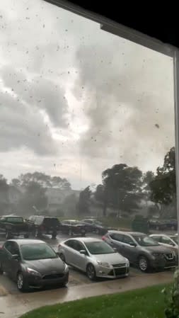 Tornado debris float in the air in South Bend, Indiana