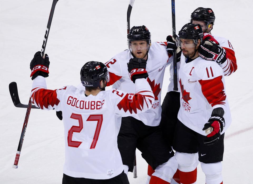 Chris Kelly of Canada celebrates scoring a goal with team mates. (REUTERS/Brian Snyder)