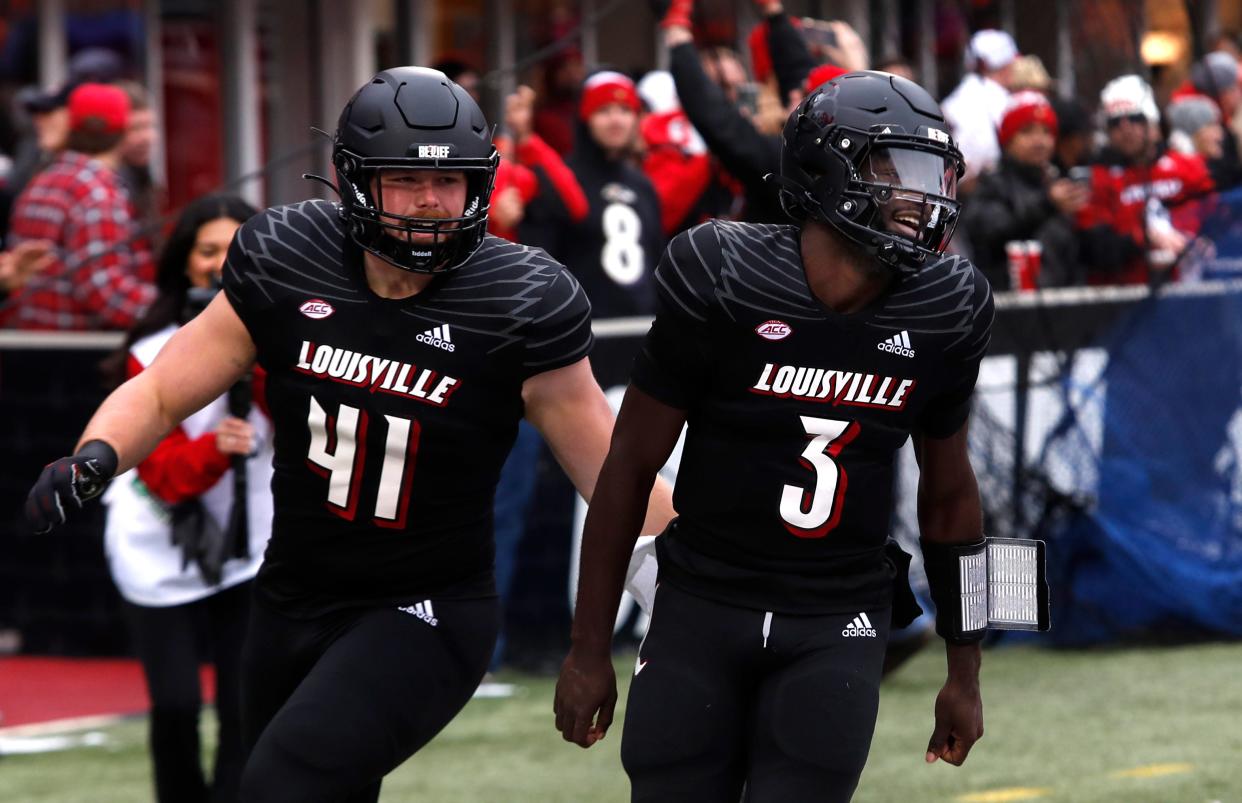 Louisville’s Malik Cunningham celebrates scoring a touchdown against Syracuse with teammate Issac Martin. Nov. 13, 2021