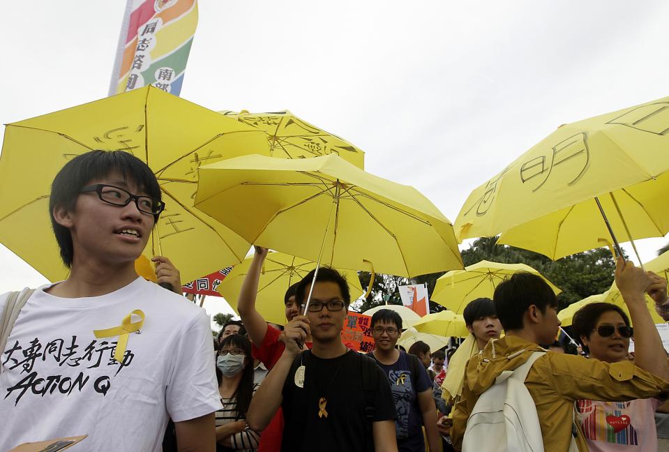 People from Hong Kong hold yellow umbrellas as they take part in the Taiwan LGBT Pride Parade in Taipei