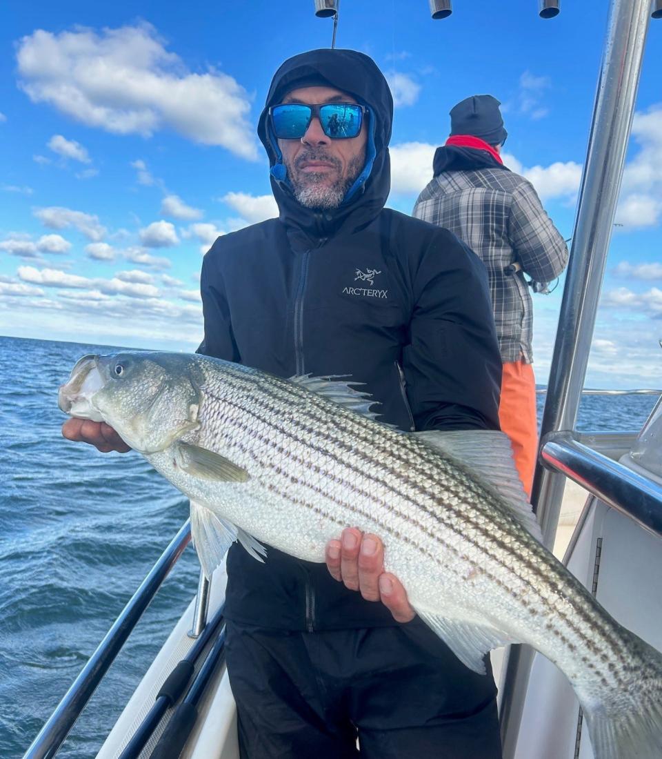 Roger Rabain from Delaware with a striped bass he landed on the Hi Flier charter boat.
