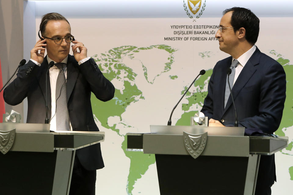 German Foreign Minister Heiko Maas, left, and his Cyprus' counterpart Nicos Christodoulides talk to the media during a press conference at the foreign ministry house in divided Nicosia, Cyprus, Tuesday, Oct. 13, 2020. Maas is in Cyprus for a one-day visit. (AP Photo/Petros Karadjias)