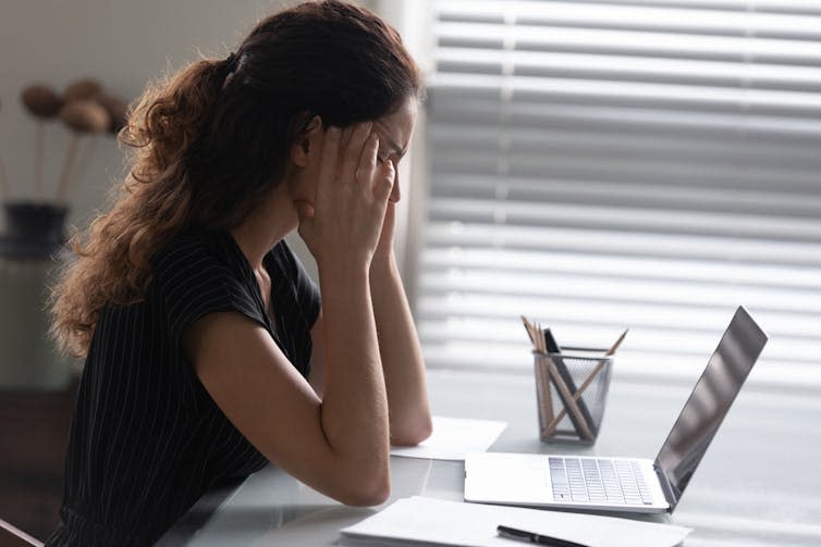 Woman struggling with a laptop