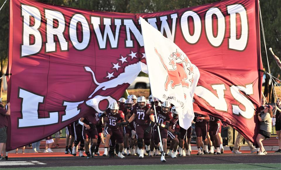 The Brownwood football team enters the field before its season opener against Wylie on Friday, Aug. 26, 2022 at Gordon Wood Stadium in Brownwood. Wylie won 30-24,