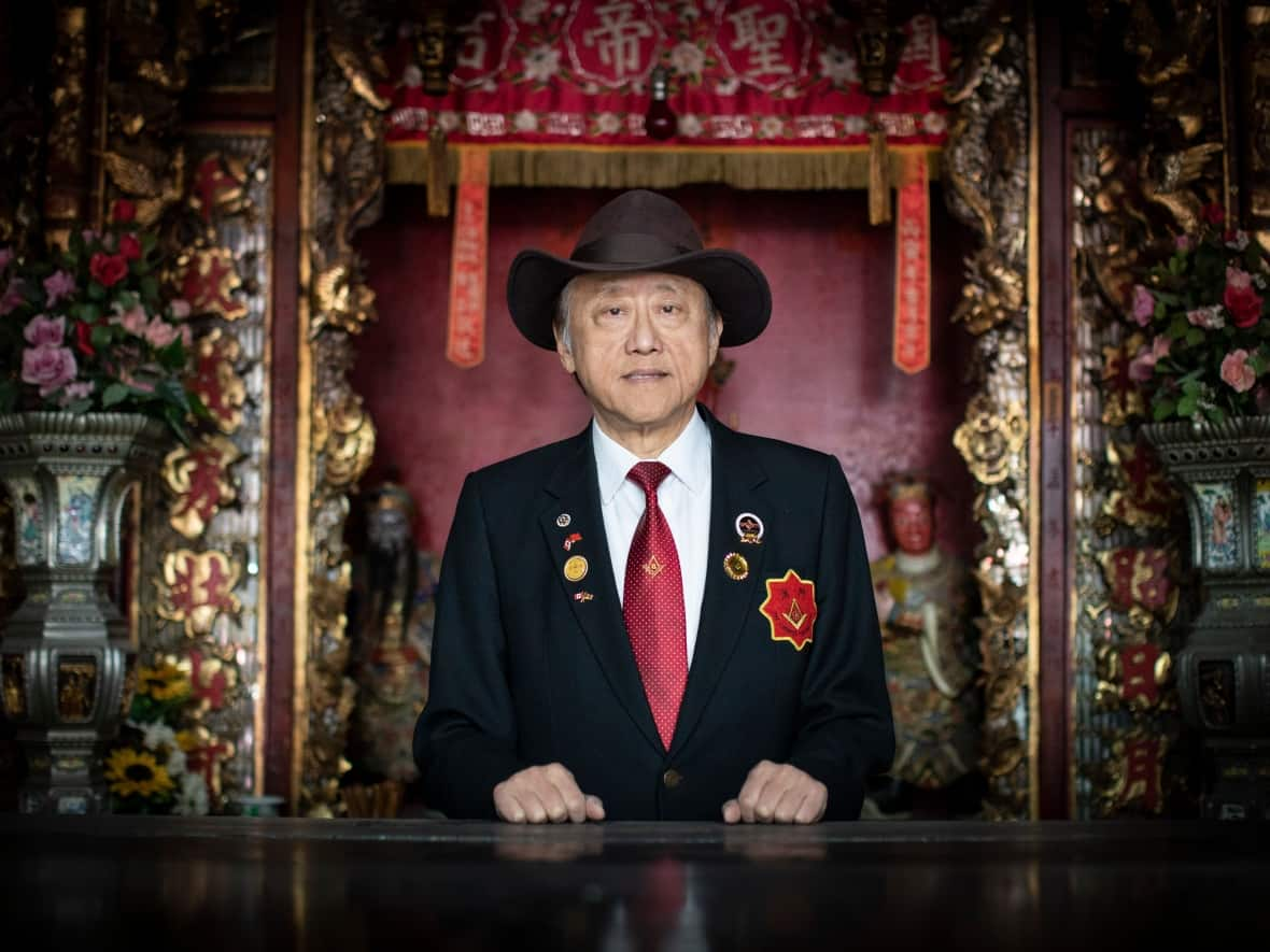 Cecil Fung, a leader of Canada's Chinese Freemasons, is pictured in front of an altar inside the organization's national headquarters in Vancouver's Chinatown. (Ben Nelms/CBC - image credit)