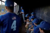 Junior baseball players with the Cadets 16u-Outerie are seen in their dugout during a game at the New Springville Little League on Staten Island in New York City