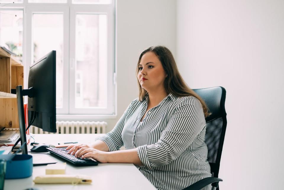 A person typing at a computer. 