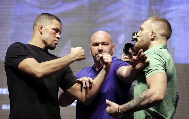 Dana White, center, stands between Nate Diaz, left, and Conor McGregor during a UFC 202 news conference. (AP)