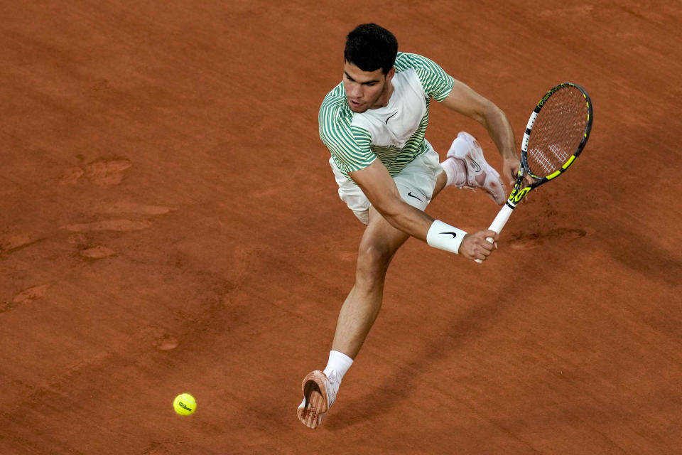 Spain's Carlos Alcaraz plays a shot against Canada's Denis Shapovalov during their third round match of the French Open tennis tournament at the Roland Garros stadium in Paris, Friday, June 2, 2023. (AP Photo/Christophe Ena)