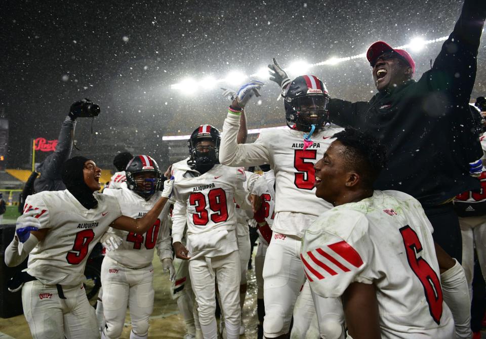 Aliquippa players celebrate with head coach Mike Warfield after they beat Belle Vernon 28-13 in WPIAL 4A Championship Saturday at Heinz Field.[Lucy Schaly/For BCT]