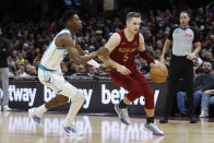 Cleveland Cavaliers guard Sam Merrill (5) drives against Charlotte Hornets forward Brandon Miller (24) during the first half of an NBA basketball game, Monday, March 25, 2024, in Cleveland. (AP Photo/Ron Schwane)