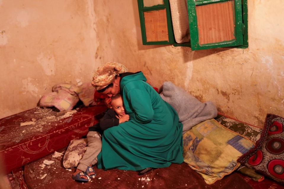 Hasna, 44, kisses her son Mohamed Jad, 5, inside their damaged house in Moulay Brahim village, in the province of Al Haouz, on Sept. 9.<span class="copyright">Nacho Doce—Reuters</span>