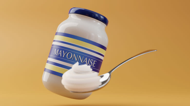 mayo jar and spoon yellow background