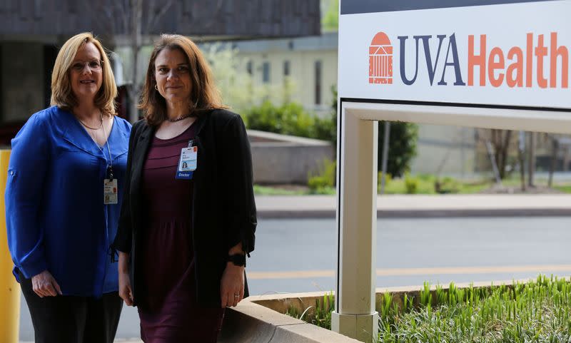 Dr. Mendy Poulter and Dr. Amy Mathers stand outside the University of Virginia Mecical Center in Charlottesville, Virginia