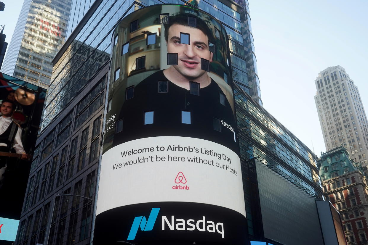 The NASDAQ market site displays an AirBnb sign featuring CEO Brian Chesky on their billboard on the day of their IPO in Times Square in the Manhattan borough of New York City, New York, U.S., December 10, 2020. REUTERS/Carlo Allegri