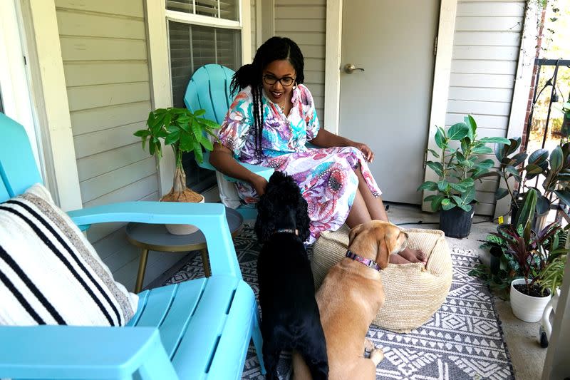 Jaleesa Garland, a marketing manager at an e-commerce startup, takes a break on her balcony while working from home in Tulsa