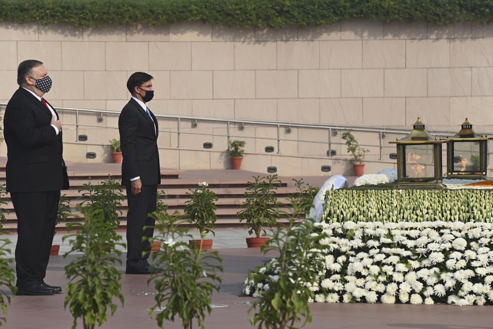 U.S. Secretary of State Mike Pompeo, left, and Secretary of Defence Mark Esper pay their tributes at the National War Memorial in New Delhi, India, Tuesday, Oct. 27, 2020. In talks on Tuesday with their Indian counterparts, Pompeo and Esper are to sign an agreement expanding military satellite information sharing and highlight strategic cooperation between Washington and New Delhi with an eye toward countering China. (Jewel Samad/Pool via AP)