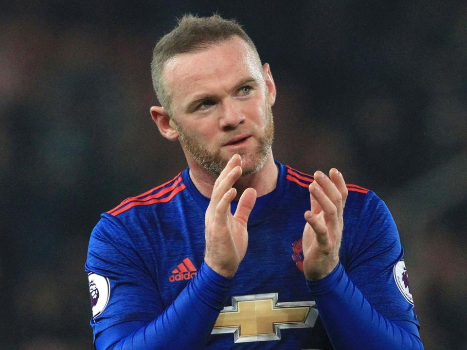 Wayne Rooney applauds the Manchester United fans after his record-breaking 250th goal: Getty