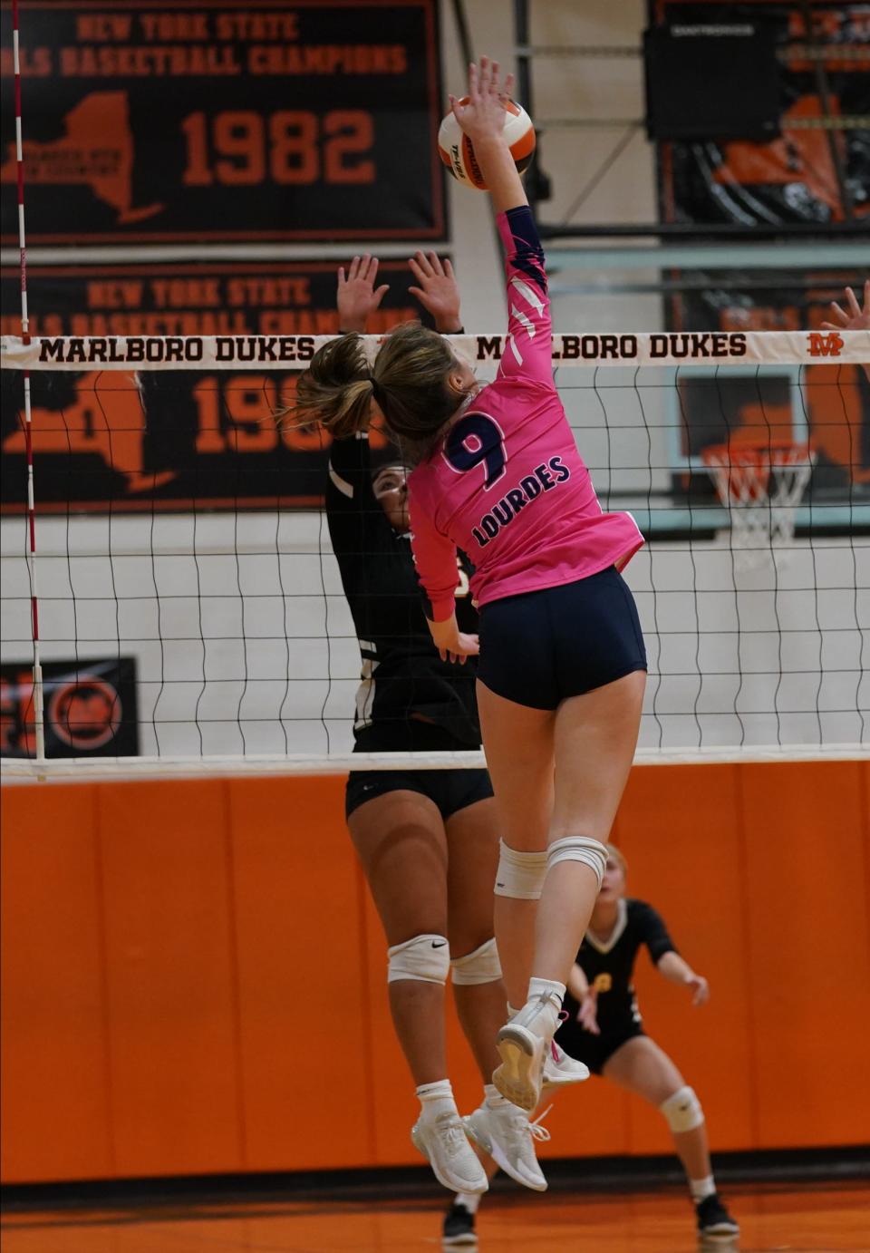 Lourdes' Madison Tegeler (9) works a shot over the net during their 3-1 win over Marlboro in volleyball action at Marlboro High School on Tuesday, October 11, 2022.