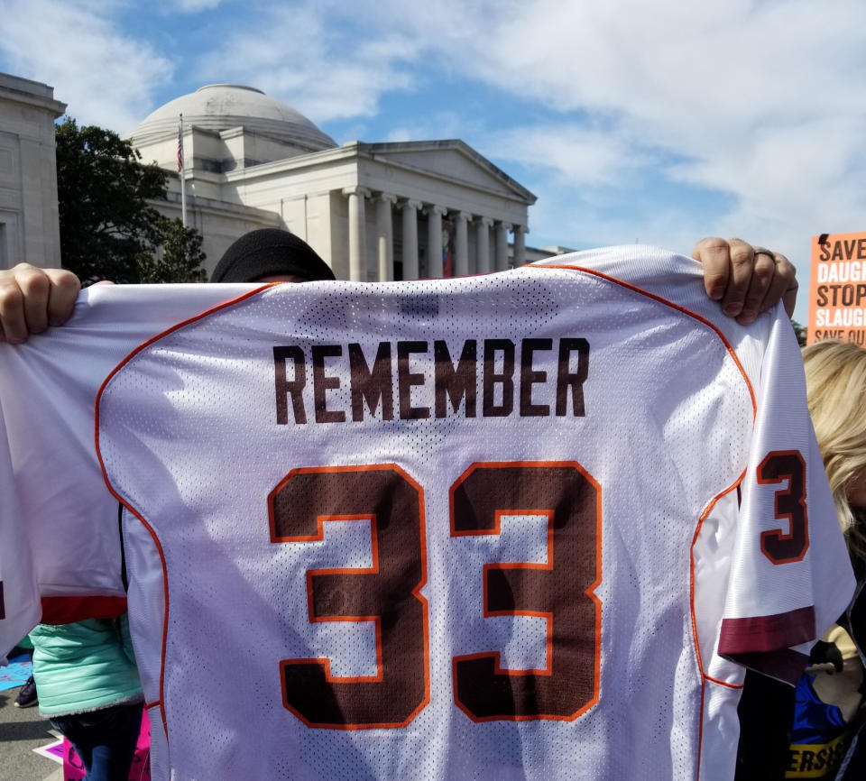 Tucker Foreman holds up his custom jersey in honor of those who died in the 2007 mass shooting at Virginia Tech. (Christopher Wilson/Yahoo News)