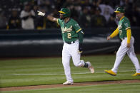Oakland Athletics' Starling Marte (2) gestures after hitting a three-run home run against the Texas Rangers during the 11th inning of a baseball game Friday, Aug. 6, 2021, in Oakland, Calif. The A's won 4-1. (AP Photo/D. Ross Cameron)