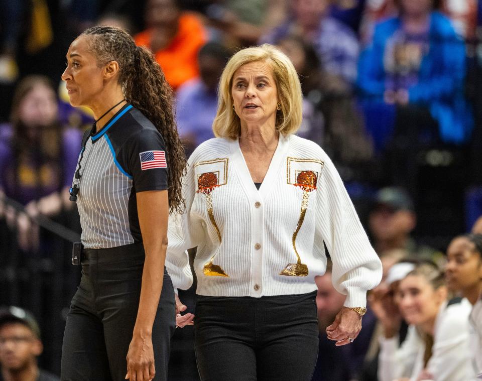 LSU head coach Kim Mulkey, right, pleads her case while walking past the referee, left, in the first period of an NCAA college basketball game against Texas A&M, Thursday, Jan. 11, 2024, in Baton Rouge, La. (Michael Johnson/The Advocate via AP)