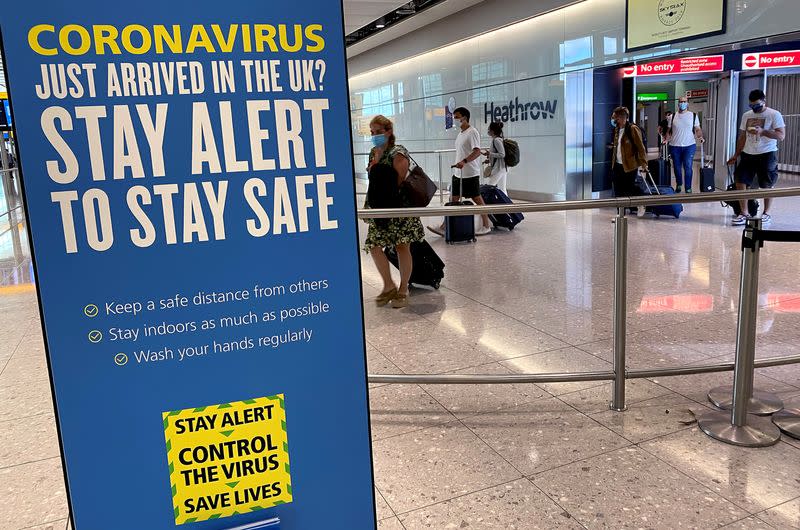 A public health campaign message is seen as passengers from international flights arrive at Heathrow Airport, following the outbreak of the coronavirus disease (COVID-19), London, Britain