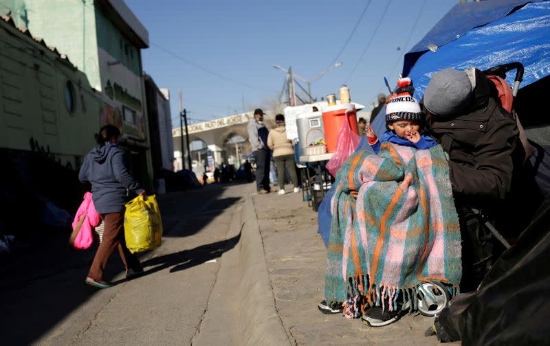 A general view shows Mexican asylum seekers, who are camping near the Paso del Norte international border crossing bridge while waiting to apply for asylum to the U.S., standing outside their tents in Ciudad Juarez