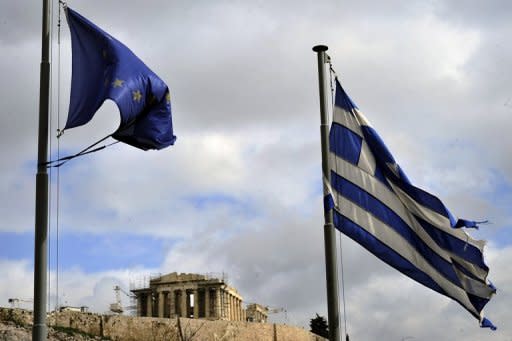 Ripped EU and Greek flags flutter in Athens. European Commission President Jose Manuel Barroso is due to meet Prime Minister Antonis Samaras as officials threw together a list of 11.6 billion euros in spending cuts to jumpstart reforms