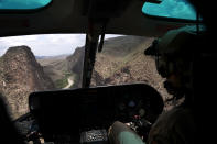 <p>A U.S. Customs and Border Protection pilot does a helicopter patrol along the U.S.-Mexico border on Aug. 1, 2017, near Lajitas, Texas. Logistical challenges, such as the rugged terrain of west Texas’s Big Bend region, are just some of the complications to building the border wall proposed by President Trump. (Photo: John Moore/Getty Images) </p>