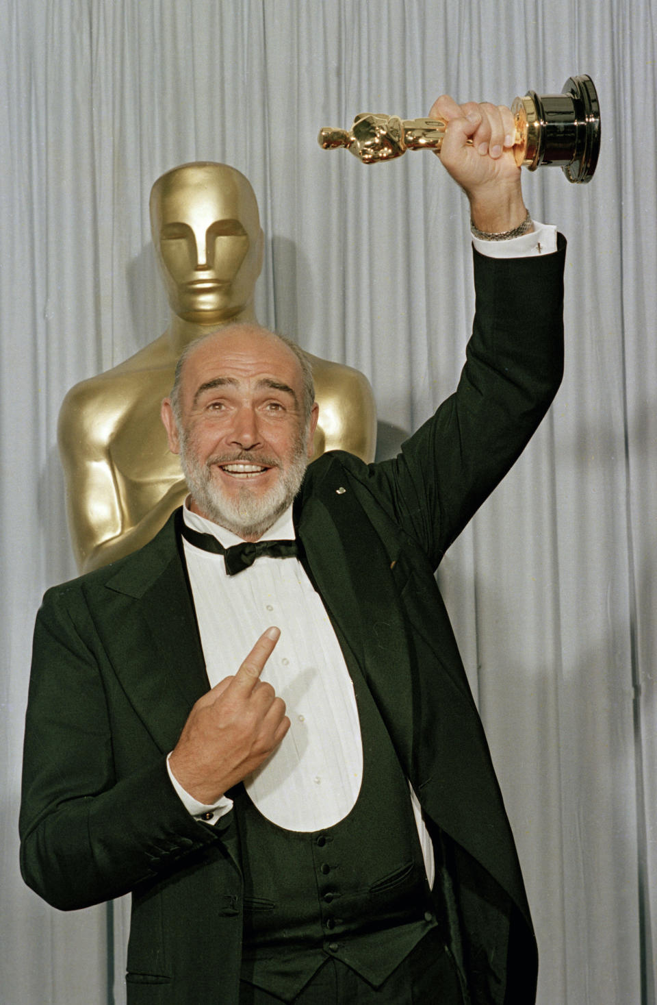 FILE - In this file photo dated April 11, 1988, Sean Connery holds up his best supporting actor Oscar for "The Untouchables" at the 60th annual Academy Awards in Los Angeles, Ca., USA. Scottish actor Sean Connery, considered by many to have been the best James Bond, has died aged 90, according to an announcement from his family. (AP Photo/Lennox McLendon, FILE)