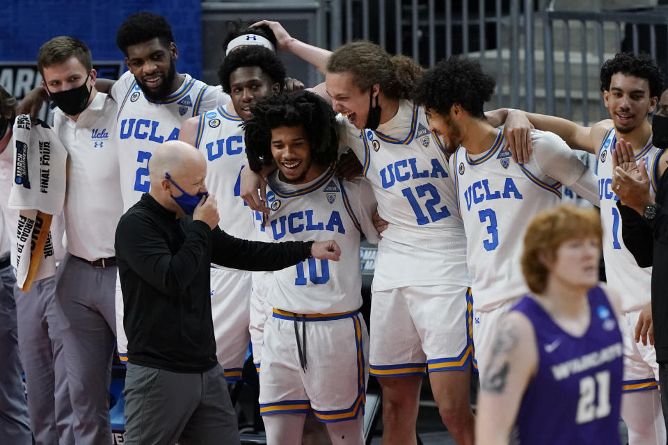 UCLA head coach Mick Cronin jokes with players in the final moments of their 67-47 win over Abilene Christian in a college basketball game in the second round of the NCAA tournament at Bankers Life Fieldhouse in Indianapolis Monday, March 22, 2021. (AP Photo/Mark Humphrey)